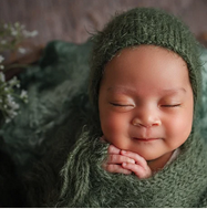 My Services: A newborn with a slight grin during their first photo session.